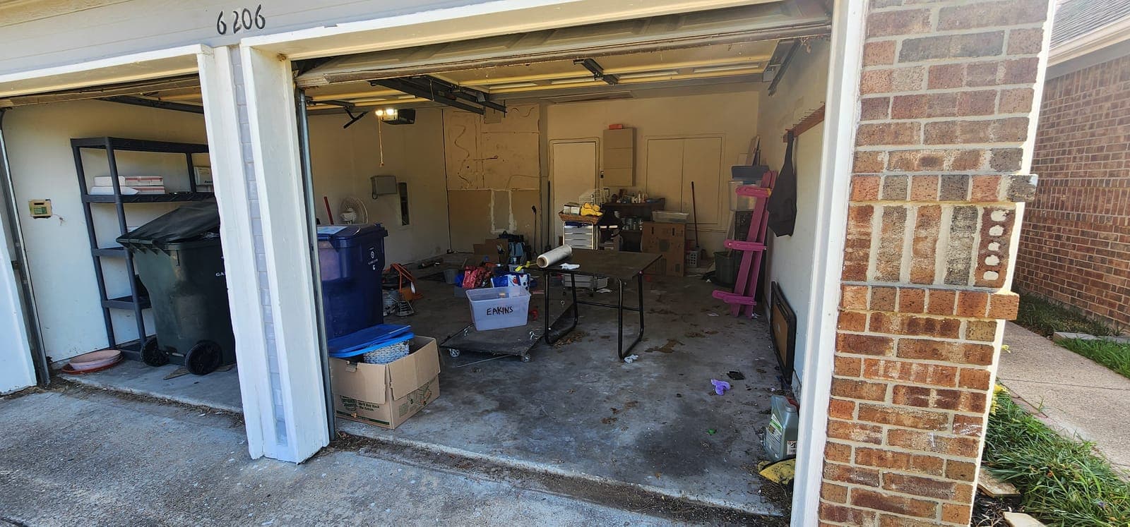 Packed garage bay — before
