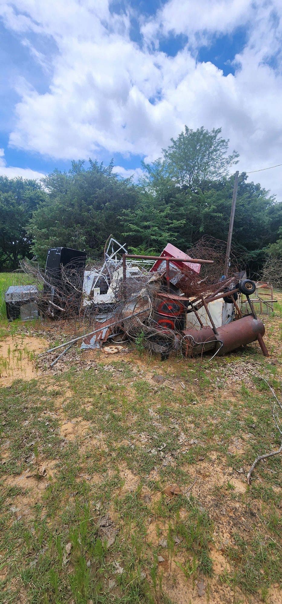 Scrap metal and debris pile — before